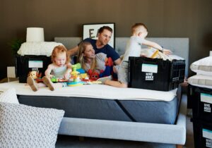 family hanging out on bed during move