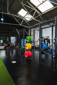 interior of a gym. Squat rack and brightly colored plate weights
